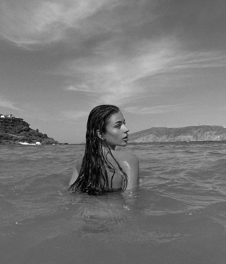 black and white photo of woman in the ocean