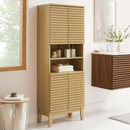 a wooden cabinet sitting next to a window in a room with white walls and flooring