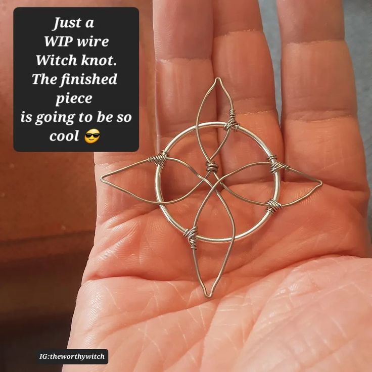 a hand holding a wire wrapped star brooch in it's palm, with the caption just a wip wire, which knot, the finished piece is going to be so cool