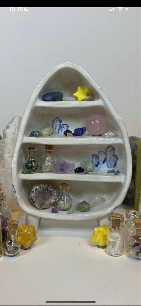 a white shelf filled with lots of glass bottles