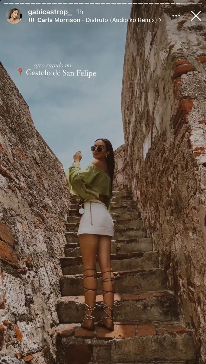 a woman is standing on some stairs