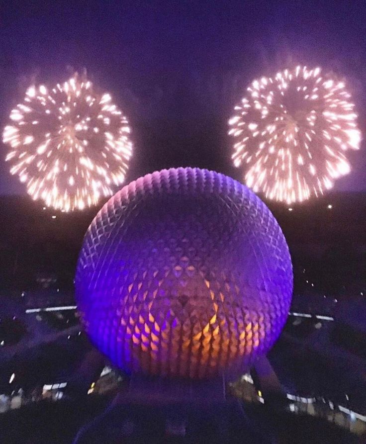 fireworks are lit up in the night sky over spaceship land