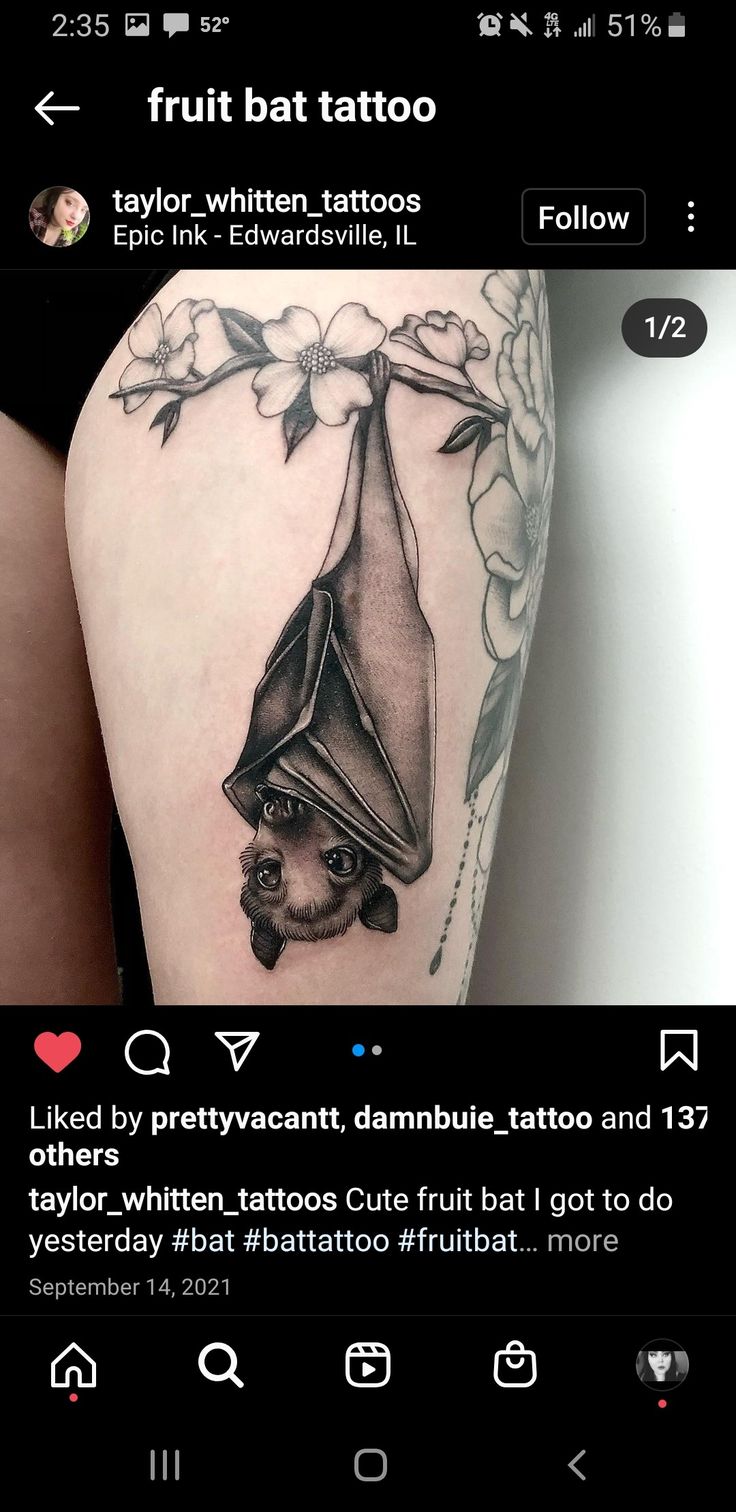 an image of a bat tattoo on someone's thigh and it looks like they are holding