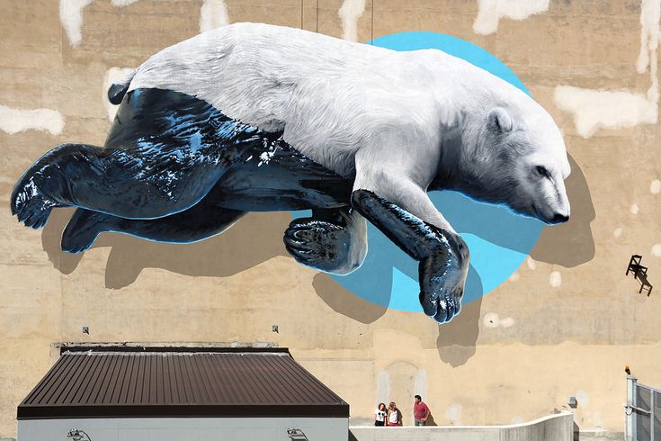 a mural of a polar bear on the side of a building