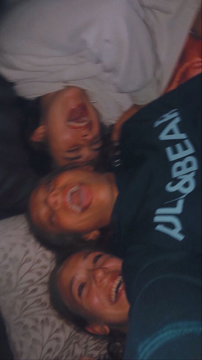 three people laying on top of each other