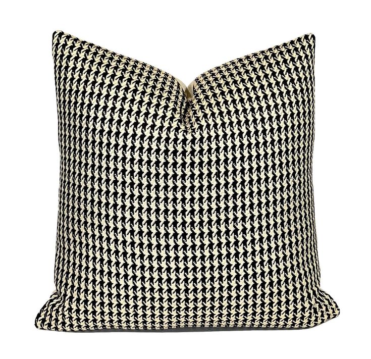 a black and white houndskin pillow on a white background with the words,'home is