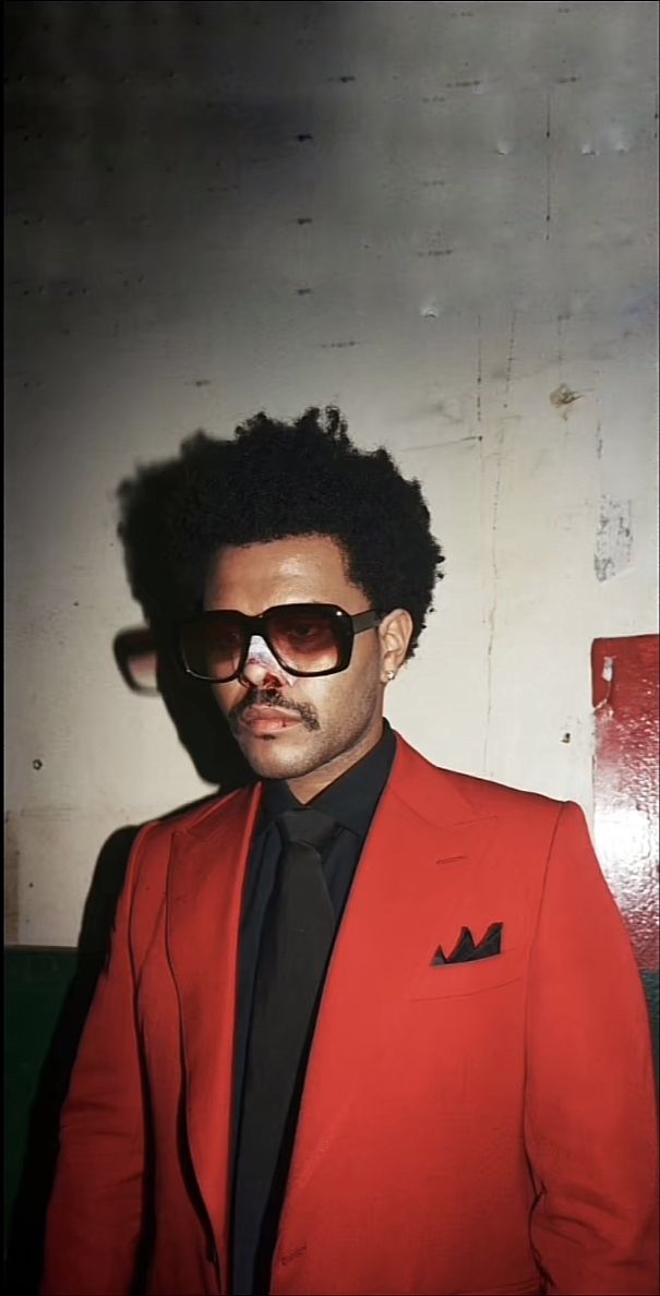 a man in a red suit and sunglasses