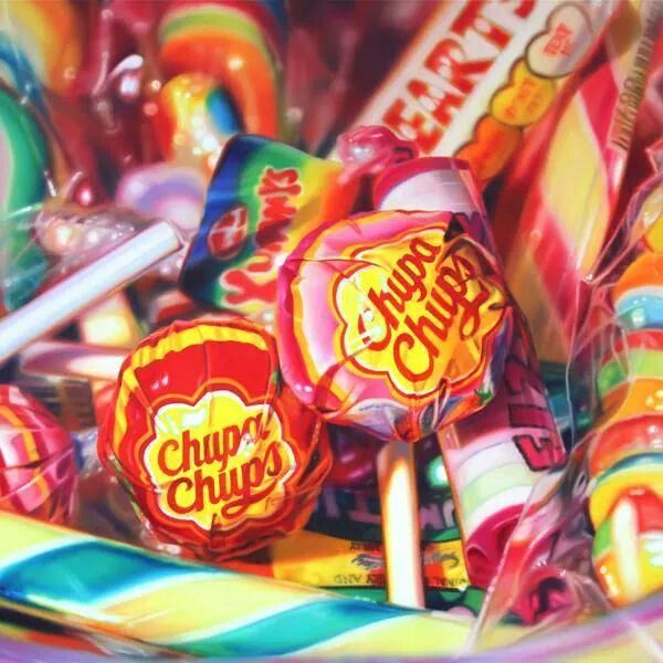 a pile of colorful candies and lollipops with the word chupp's chups on them