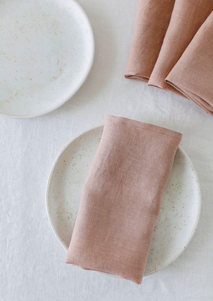 napkins and plates on a white table cloth