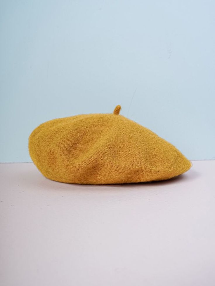 a yellow hat sitting on top of a white table