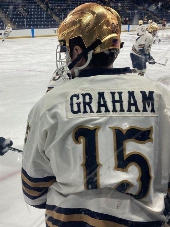 an ice hockey player is standing on the ice with his goalie's gear