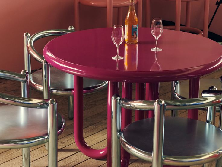 a table with four chairs and two wine glasses sitting on top of it next to each other