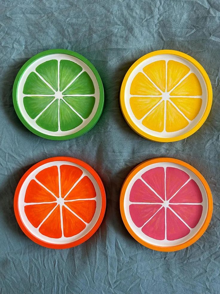 four slices of fruit sitting on top of each other in front of a gray background