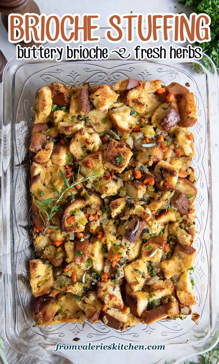 a square casserole dish filled with bread and veggies on a glass platter