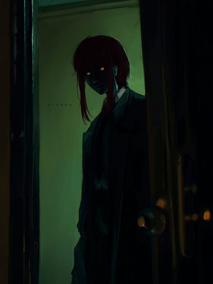 a person with red hair standing in a doorway