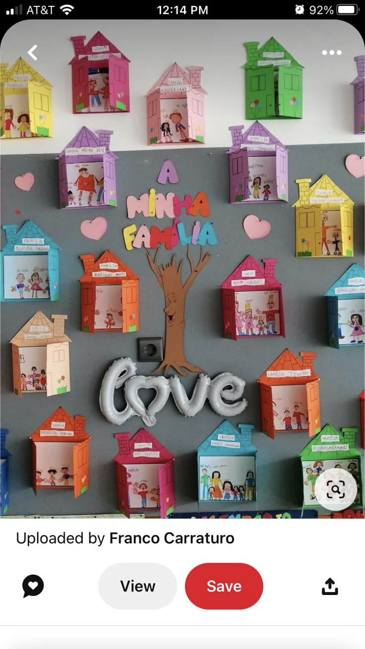 the wall is decorated with paper houses and magnets for valentine's day or any other special occasion