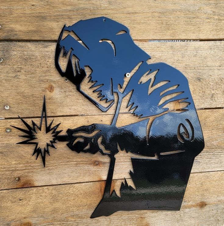 a metal cut out of a man holding a star on top of a wooden table