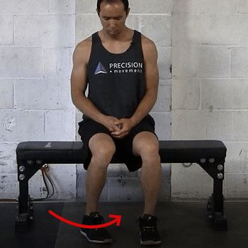 a man sitting on top of a bench in front of a brick wall with an arrow pointing to the chest