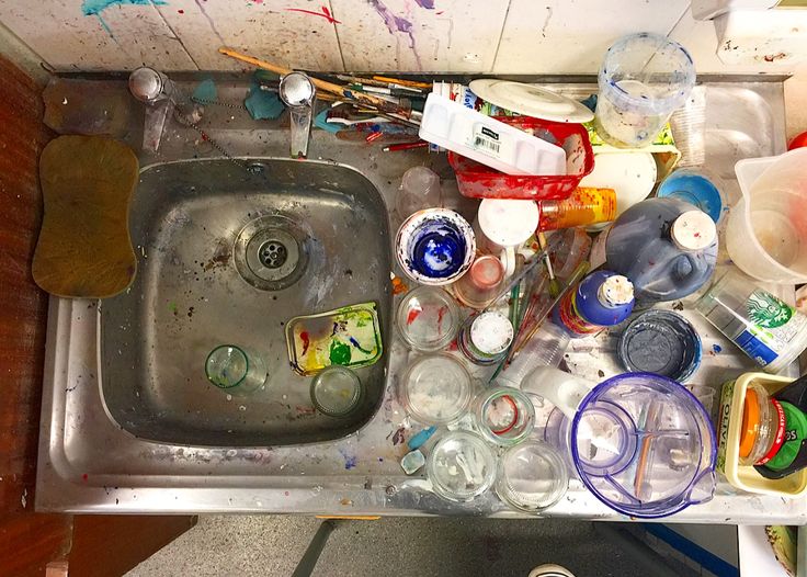 a sink filled with lots of bottles and other items