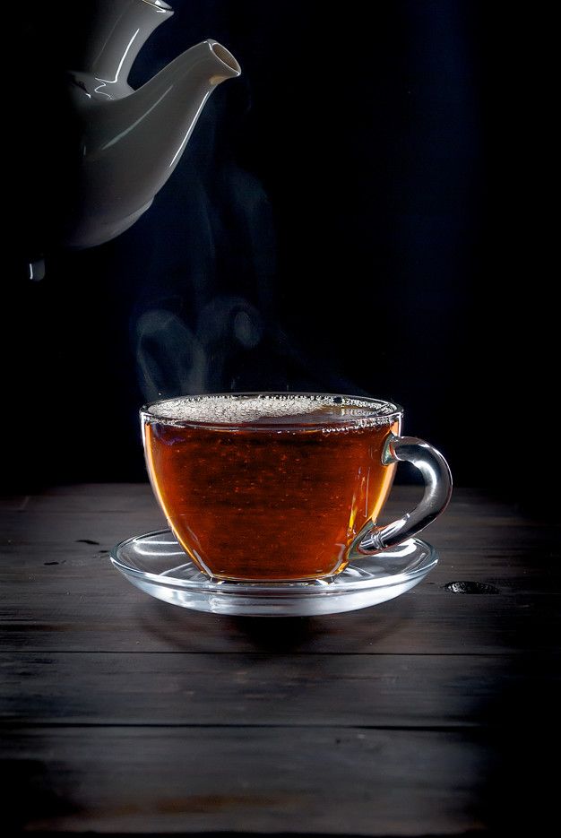 tea being poured into a glass cup