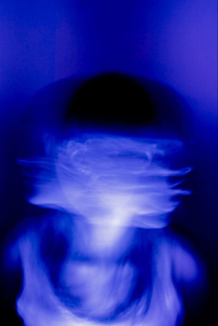 a blurry photo of a person's head in blue light