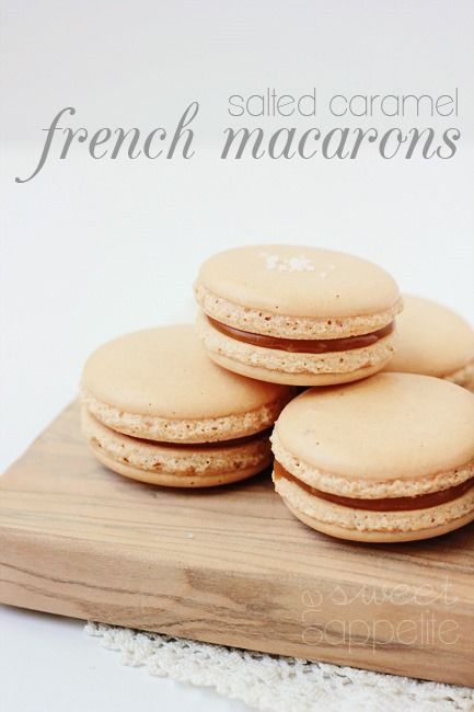 four french macarons on a cutting board with the words salted caramel