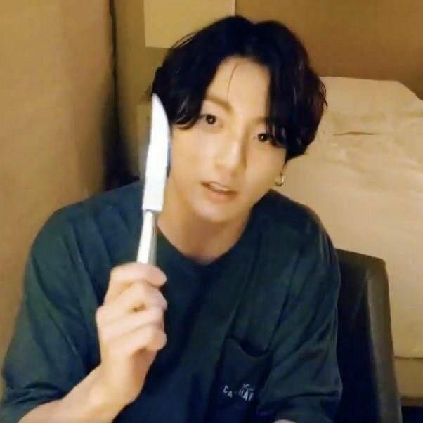 a person holding up a toothbrush in front of their face and looking at the camera