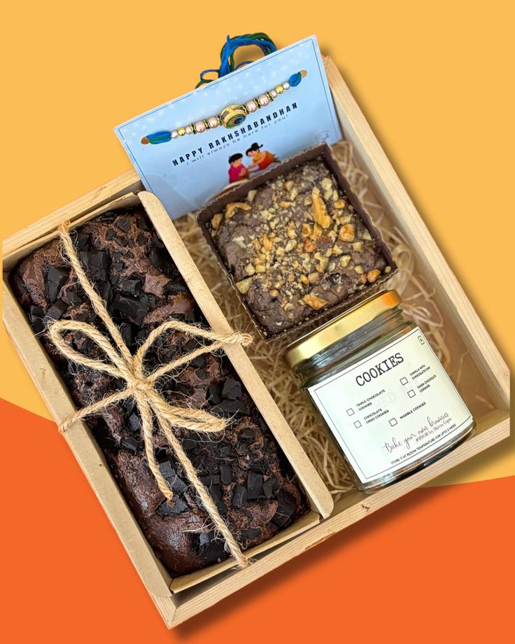 an open box filled with brownies and nuts next to a jar of peanut butter