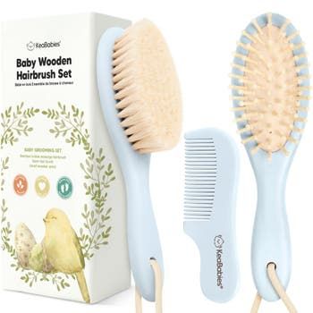 the baby wooden hairbrush set is next to its box