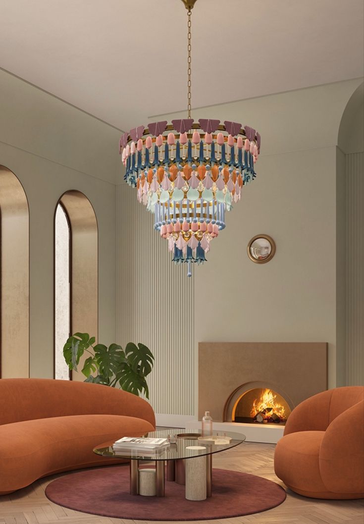 a living room with two orange chairs and a chandelier hanging from the ceiling