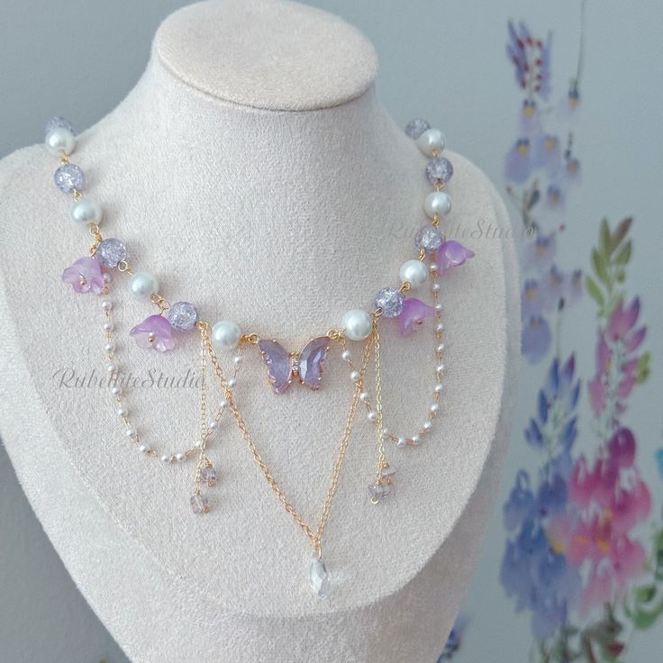 Step into a world of enchantment with our handmade Violet Fairy Blossom Choker Necklace, a magical accessory that captures the essence of fairy and princesscore aesthetics. Adorned with a stunning violet crystal butterfly centerpiece, surrounded by delicate glass beads and flowers, this necklace is designed to add a touch of whimsical charm to your look. 🌸 Key Features: Violet Crystal Butterfly: The centerpiece of this necklace is a captivating violet crystal butterfly, symbolizing transformati Purple Aesthetic Necklace, Princess Necklace Aesthetic, Magical Girl Necklace, Fairy Jewelry Bracelet, Purple Butterfly Necklace, Fairy Necklace Diy, Purple Necklace Aesthetic, Butterfly Bead Pattern, Handmade Beaded Necklaces Design