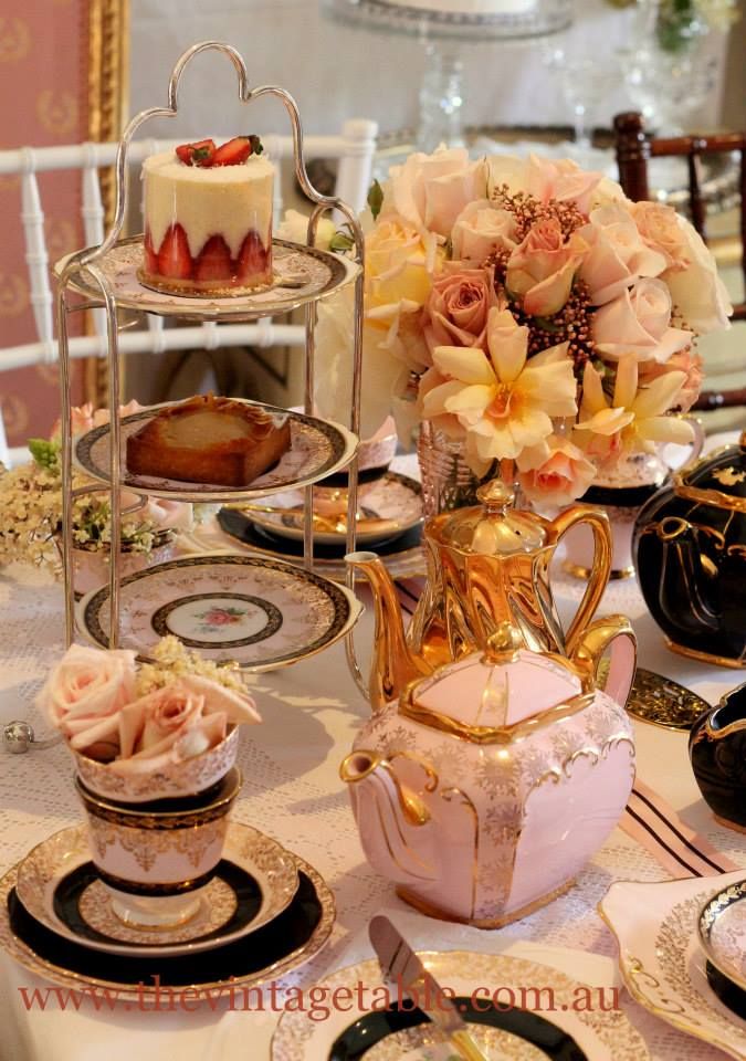 a table topped with plates and cups filled with cakes