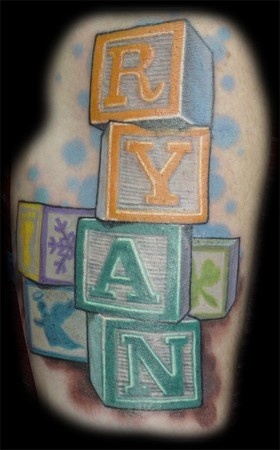 a colorful tattoo with blocks and letters on it