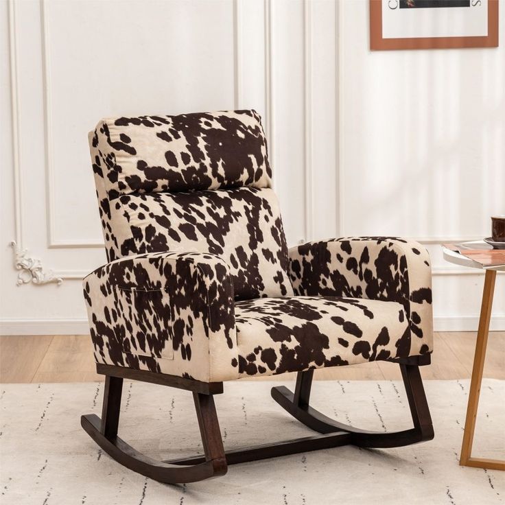 a cow print rocking chair in a living room