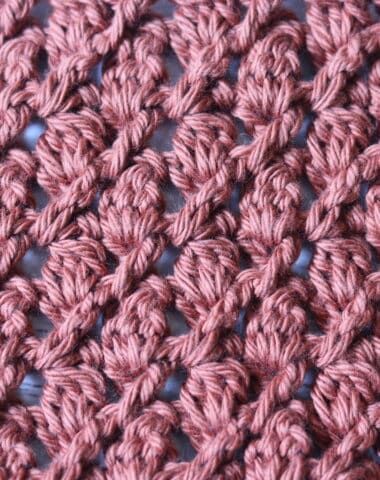 crochet stitches on the side of a piece of pink fabric that has been stitched together