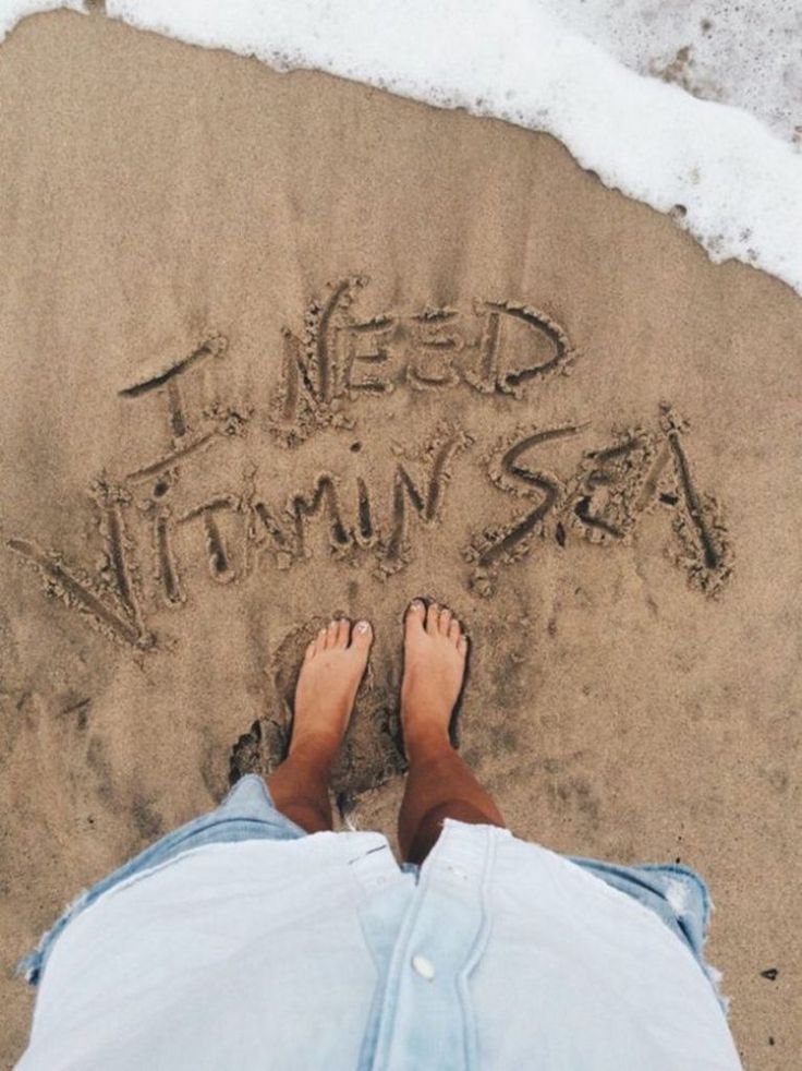 someone is writing in the sand with their feet