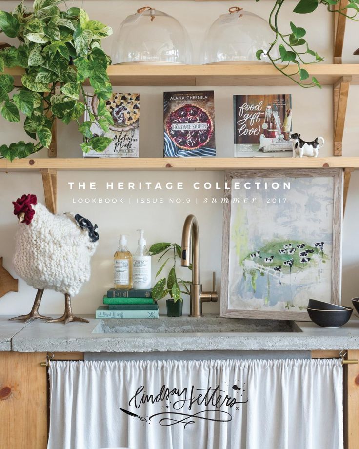 the heritage collection is on display in front of a kitchen counter with plants and other items