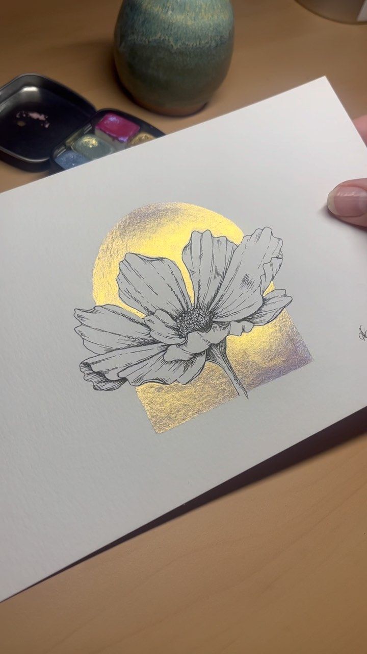 a drawing of a flower is shown in front of a phone