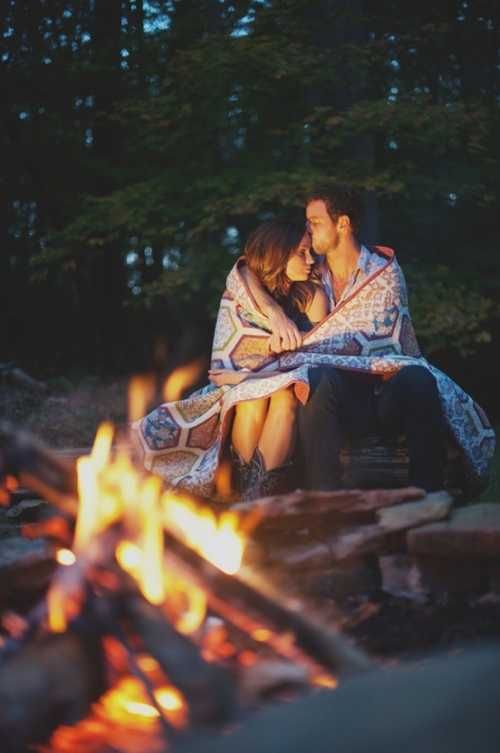 two people sitting next to each other in front of a campfire with the caption saying, i love you