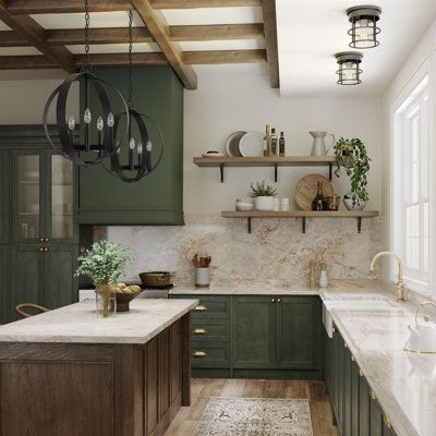 a kitchen with green cabinets and marble counter tops, an island in the middle is surrounded by hanging lights