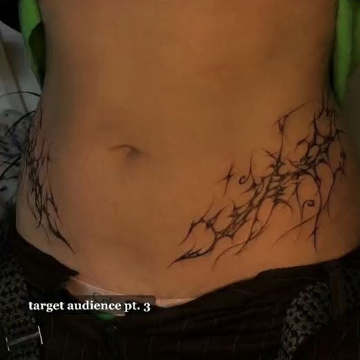 a woman's stomach with vines on it