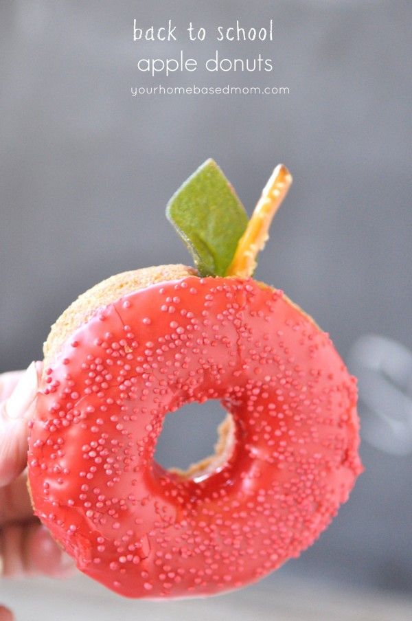 the back to school apple donut is being held by someone