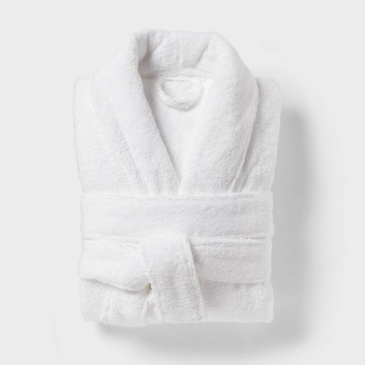 Make every day feel like a spa day by wrapping yourself in this Spa Plush Bath Robe from Threshold™. Crafted from 100% terry cotton and featuring a plush design, this V-neck bathrobe feels soft against your skin as you bundle up after a shower. Designed in a solid white hue, it features an open-front design with a shawl collar for easy on and off. A front tie with belt loops offers you a customizable fit, while two large front pockets come in handy for keeping your phone or grooming essentials c Terry Cloth Bathrobe, Black Flower Dress, Terry Robe, Plush Design, Target Gifts, One Piece Clothing, One Piece Pajamas, Spa Day, Shawl Collar