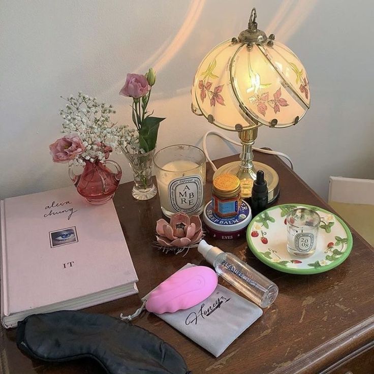 an assortment of items on a table next to a lamp