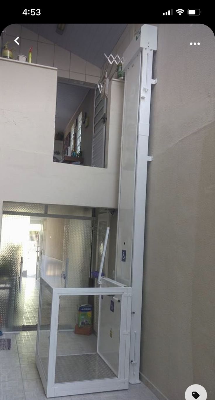 the inside of a room with a glass door and some shelves on the wall next to it