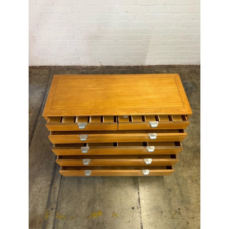 a wooden table with six drawers on it