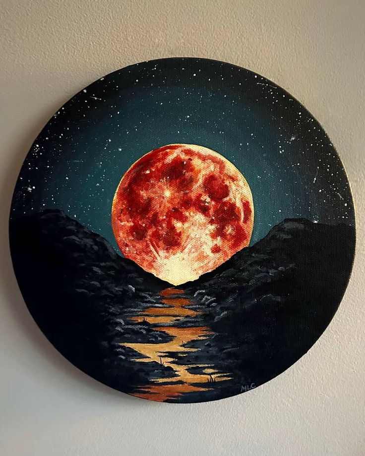 a painting of a full moon on a wall