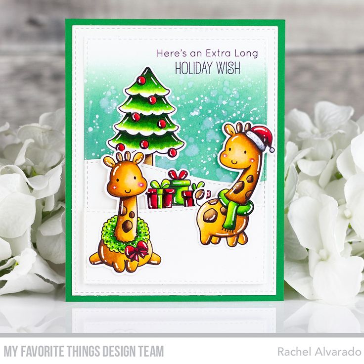 a card with two giraffes and a christmas tree in front of white flowers