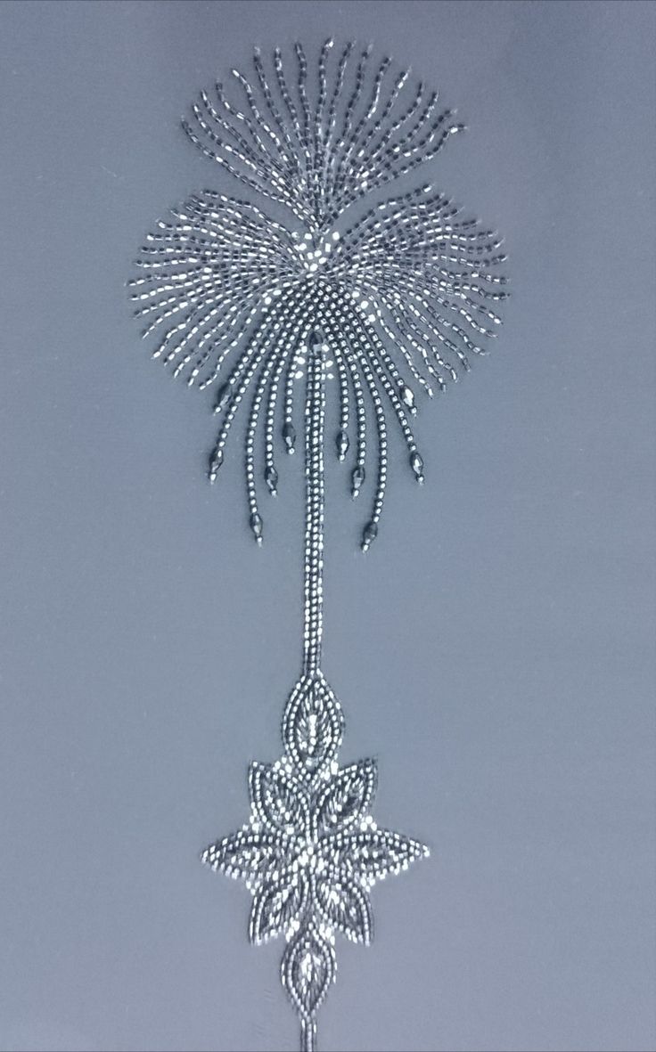 a silver christmas ornament hanging from the ceiling