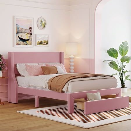 a bedroom with pink furniture and decor in the corner, including a bed frame that has two drawers on each side